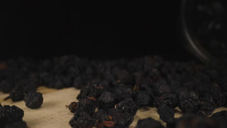 Wild-Blueberries-Fresh-Dried-Ripe-Fruits-on-Wooden-Board,-Dolly-Backwards-Close-Up-Probe-Lens-Studio-Shot,-Exotic-Dry-Berry-Food-Product-with-Dark-Background