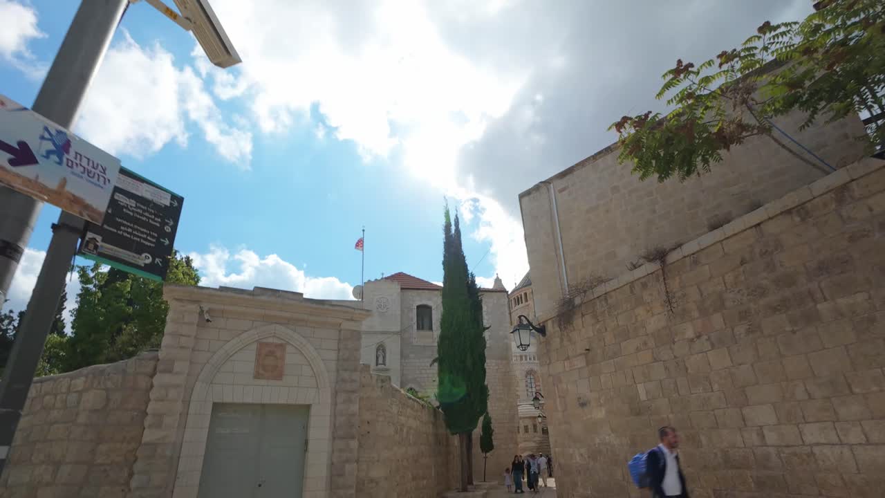 Hyperlapse walking toward the Dormition Abbey on Mount Zion in Jerusalem under a bright sun flare