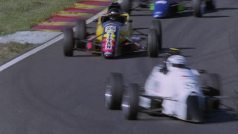 formula cars racing on a circuit track