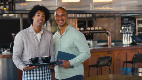 portrait of male staff team working in restaurant or coffee shop