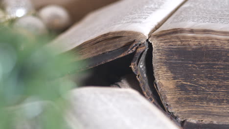 Close-up-of-old-Bible-book-with-candle-smoke