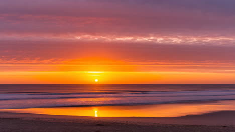 vibrant golden sunset over a serene ocean and beach