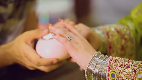 bride using a uv light nail drier to dry her manicure, close up view