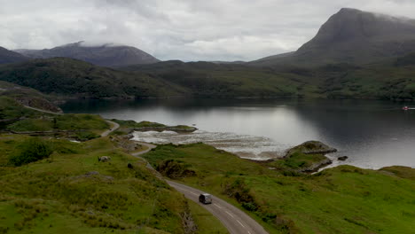 drone shot of winding road near the kylesku bridge in north-west scotland that crosses the loch a' chàirn bhàin in sutherland