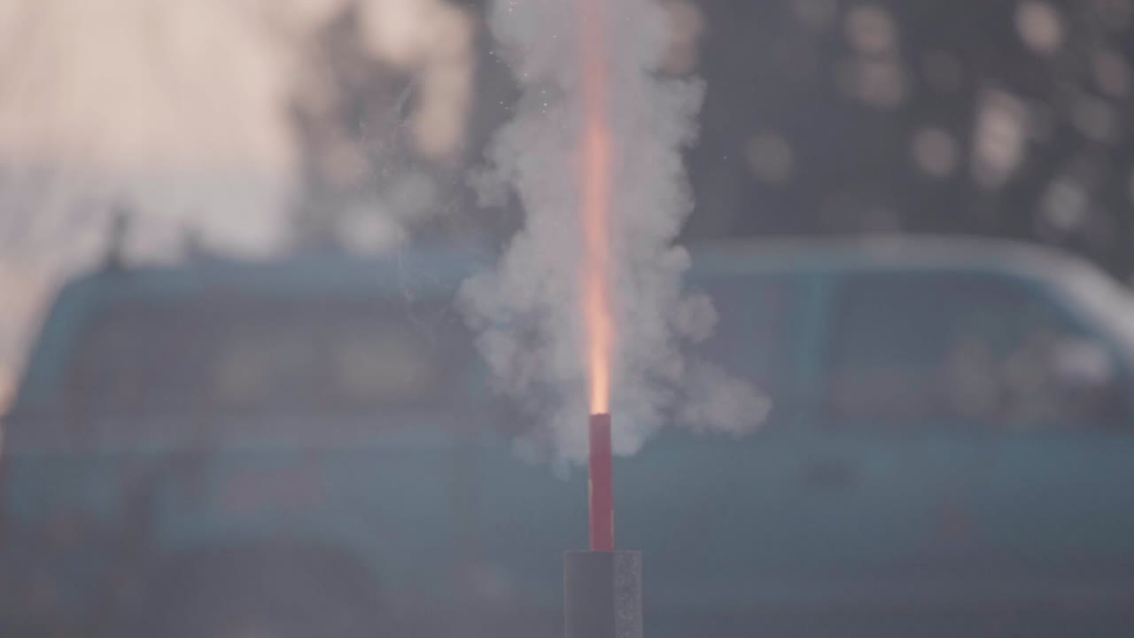 An areal firework fuse burning and explosion or discharge of the firework