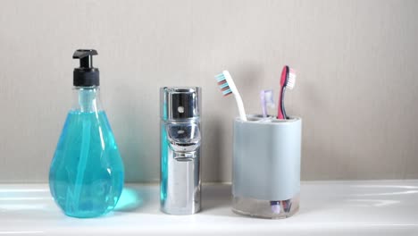 bathroom sink with soap dispenser, toothbrush holder, and faucet