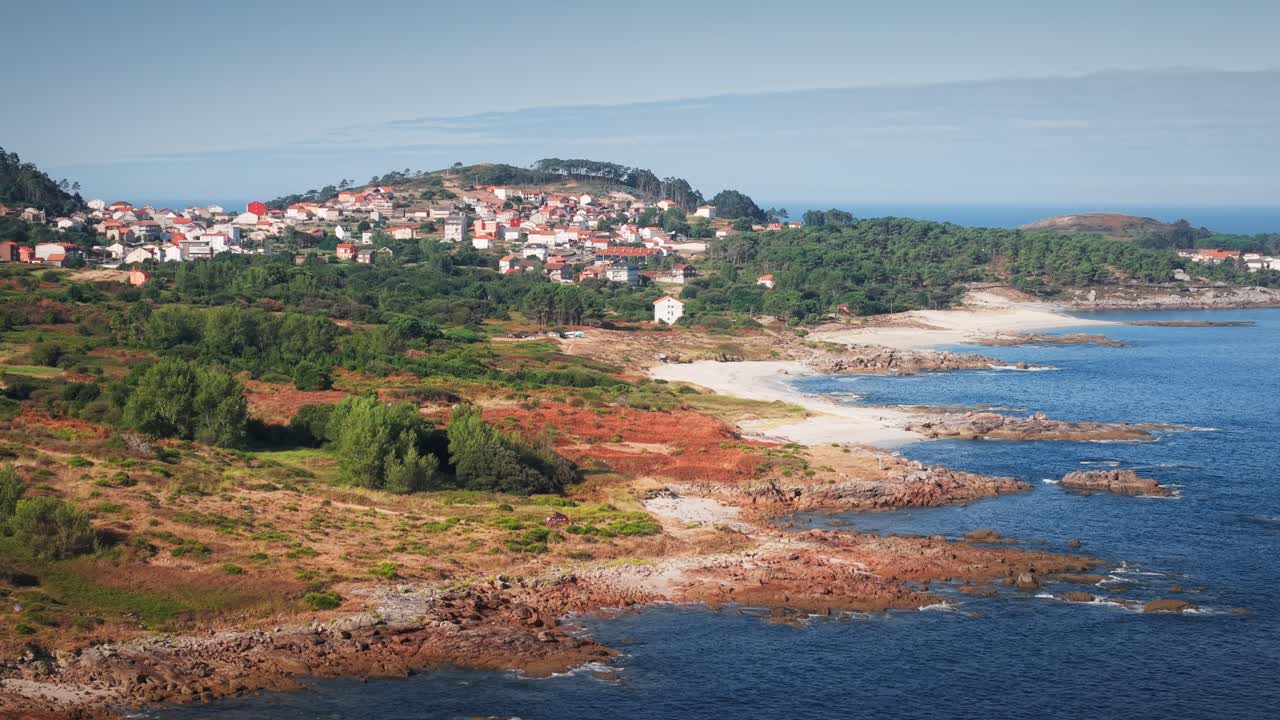 Panoramica del drone con teleobiettivo lungo la costa rocciosa dell'Atlantico che rivela la città di Lira e il suo litorale in Galizia, Spagna