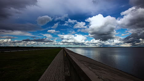 Rain-clouds-and-rainbow-are-moving-in,-on-coastline-island-Time-Lapse