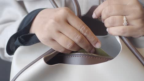 woman putting credit card into purse