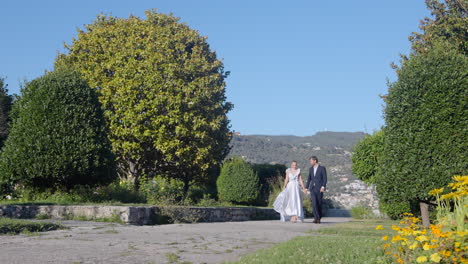 couple walking in a park on their wedding day