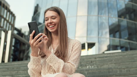 woman using smartphone on stairs outdoors