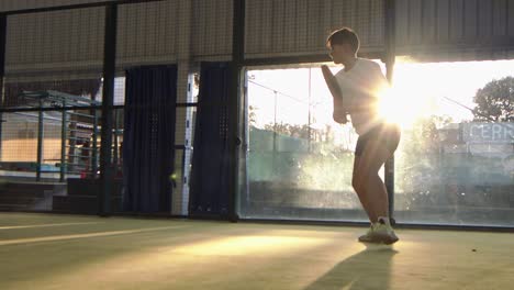 hispanic woman in a padel match returns a serve - slow motion