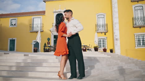 salsa performers dancing street stairs. latin dance partners moving energetic.