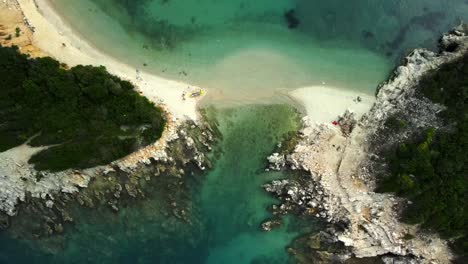 Aerial-rising-from-the-white-sand-beaches-twin-islands-Ksamil,-Albania