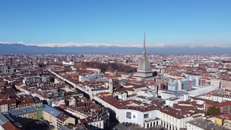 aerial reveal of turin city with landmark mole antonelliana - sunny day