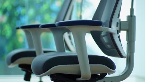a serene workspace featuring adjustable modern office chairs against a bright green background, ideal for enhancing comfort and productivity in any setting
