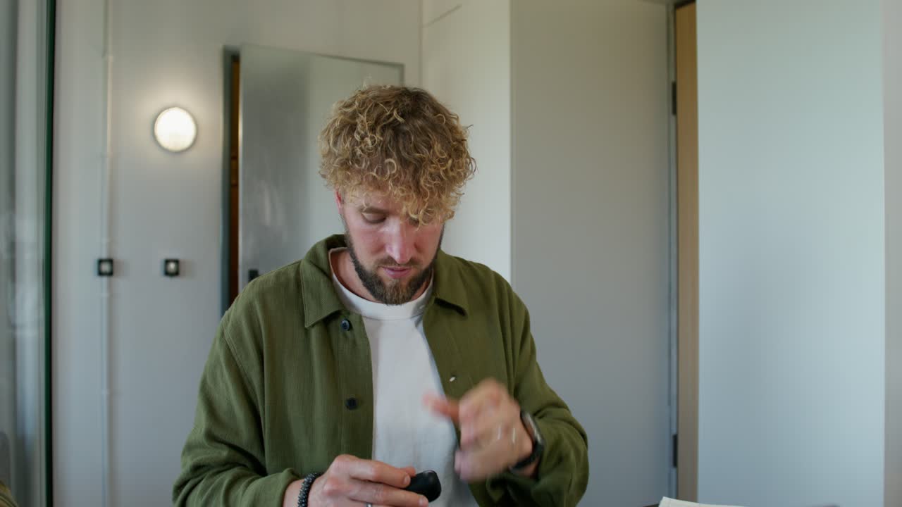 Man in a room, possibly on a video call