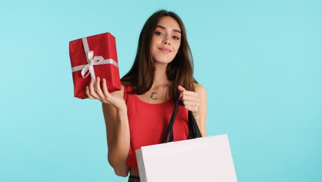 caucasian cheerful woman posing in front of camera on blue background.