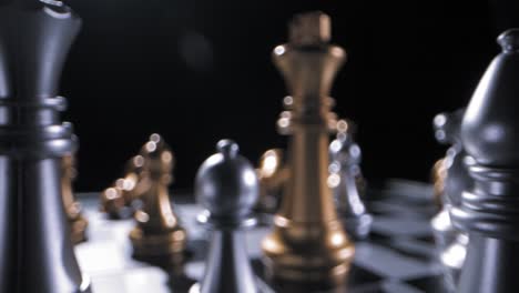 shallow focus trucking shot of gold and silver pieces on chess board