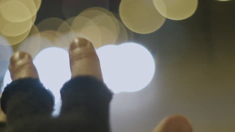 abstract scenery of hand in gloves in front of traffic lights bokeh