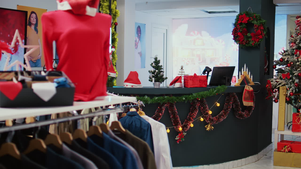 toma izquierda en camión de una tienda festiva del centro comercial llena de adornos de árboles de navidad, guirnaldas y adornos durante la temporada de vacaciones de invierno. tienda de moda navideña vacía y adornada con ropa en exhibición
