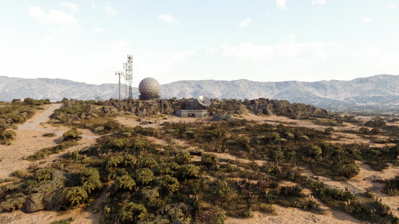 Remote mountain site with radar and communication towers in blue sky