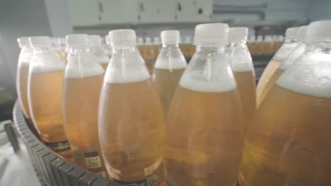 conveyor belt with bottles for juice or water at a modern beverage plant. modern production of sweet soda water