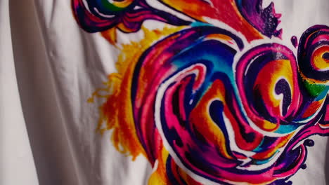 woman artist in creative studio with colorful tie-dye textile