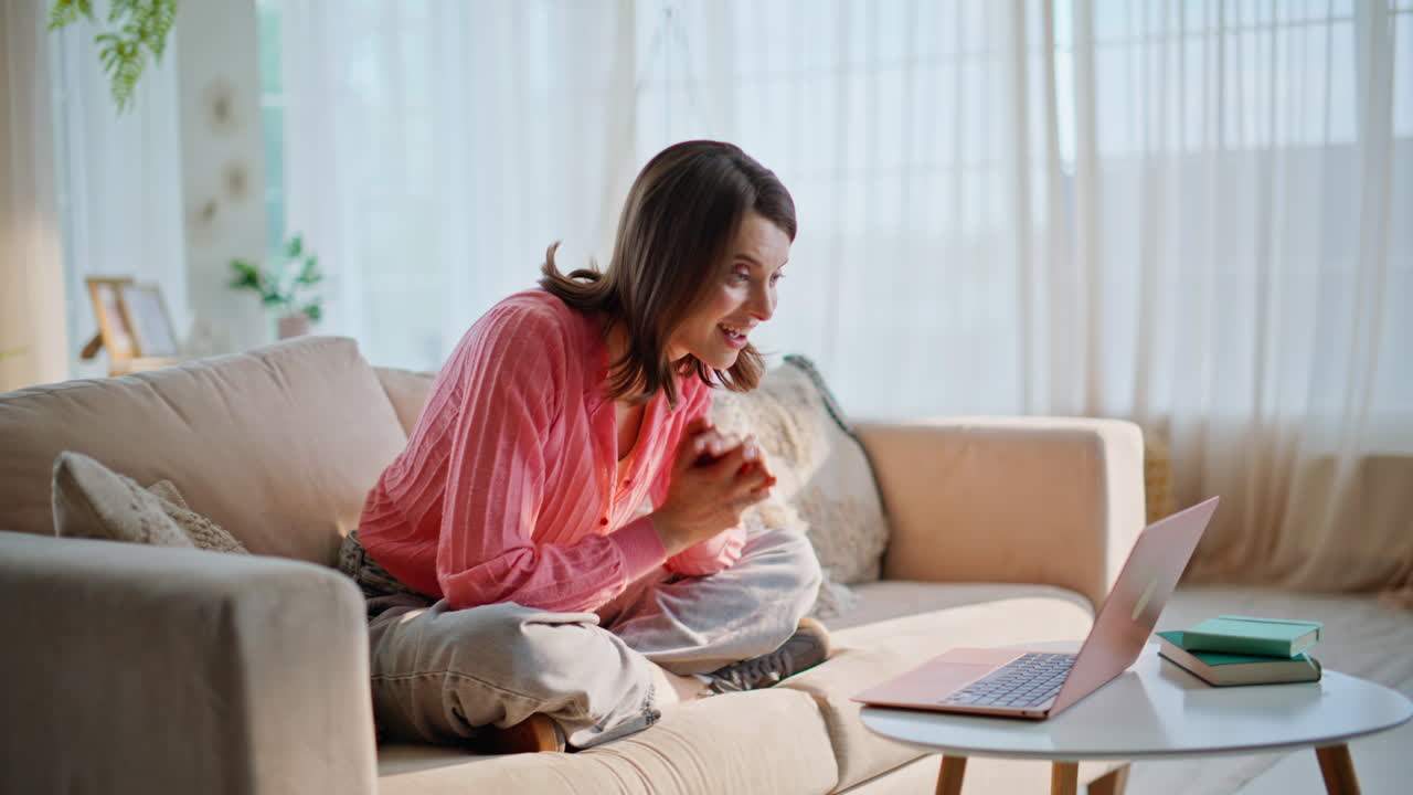 Lady waving hand webcam laptop conducting virtual conference from apartment