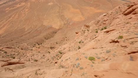 FPV-drone-flying-down-red-rock-cliffs-of-Antelope-Pass-Vista-in-Arizona