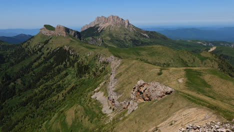 zoom in landscape view of the rocky caucasus mountains valleys and forests, on a sunny day