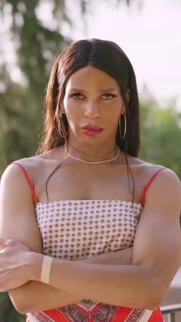 portrait of a person with long hair and crossed arms