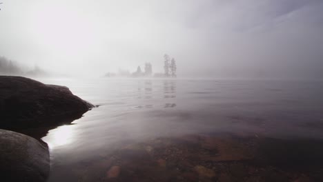 foggy dramatic scene looking across swan lake in montana