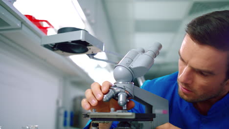 Researcher-man-working-with-microscope-in-lab.-Doctor-doing-microscope-research