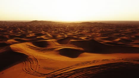 aerial view of 4x4 off road land vehicle taking tourists on desert dune bashing safari in dubai, uae