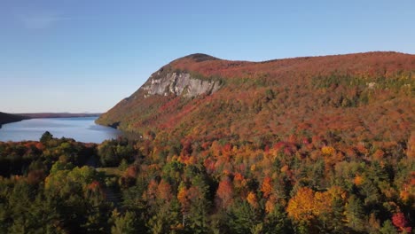 Beautiful-aerial-drone-footage-of-the-fall-leaves-on-and-around-Mount-Hor,-Mount-Pisgah,-and-Lake-Willoughby-during-peak-autumn-foliage-at-Willoughby-State-forest-in-Westmore,-Vermont