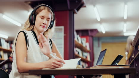 woman studying in library with headphones
