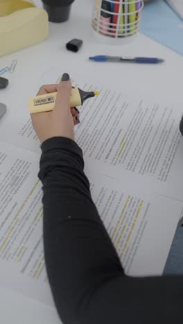 hand highlighting text on documents