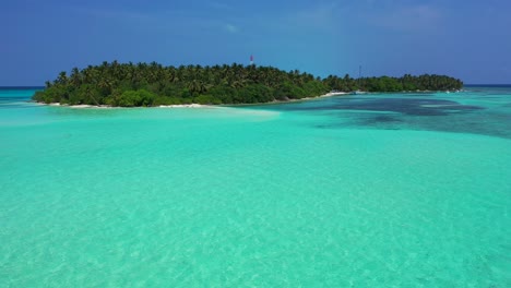 Calm-crystal-water-of-turquoise-lagoon-surrounding-tropical-island-with-lush-vegetation-and-palm-trees-forest-under-violet-sky-of-morning-in-Seychelles