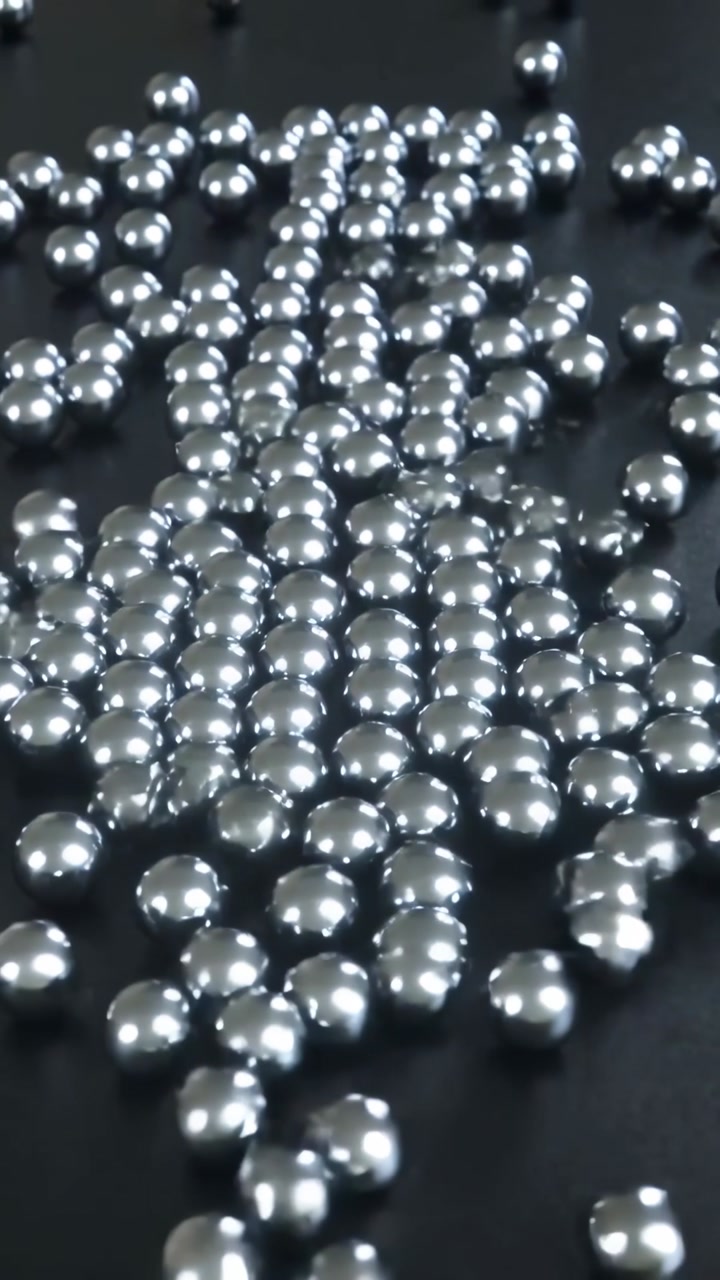 Shiny Metallic Spheres Spreading on a Dark Surface