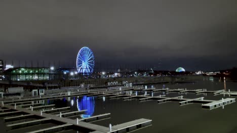 static night panoramic shot of île sainte-hélène with a view of old port, parc jean-drapeau, la ronde, le monstre and a flock of birds in the city of montreal, canada