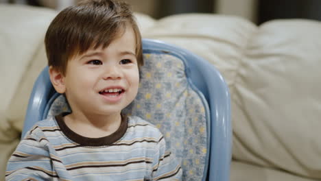 a cool asian kid changes his facial expression from sadness to joy. emotional response.