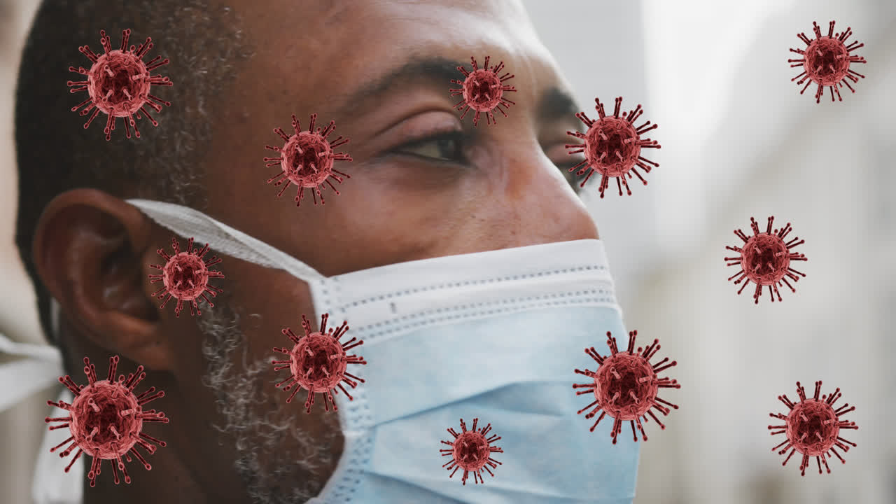 Animation of covid 19 cells over african american man wearing face mask