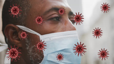 animation of covid 19 cells over african american man wearing face mask