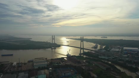 Vuele-Sobre-El-área-Urbana-Hacia-El-Río-Y-El-Gran-Puente-Colgante-Moderno-A-La-Luz-De-La-Mañana,-Parte-Tres