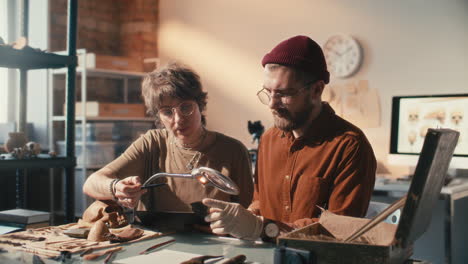 two archaeologists working together on artifact research in laboratory