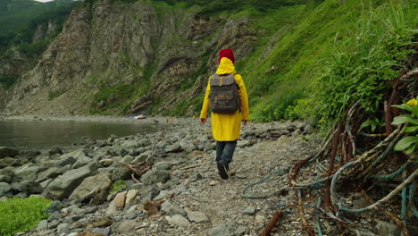 person hiking along a rocky coastline