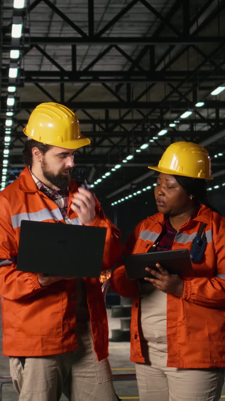 Vertical Video Diverse engineers supervising metalwork and welding operations