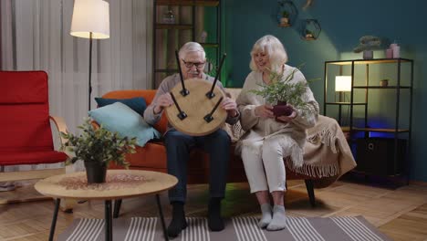 senior mature old man woman family assembling furniture at home collect repair fixing teamwork