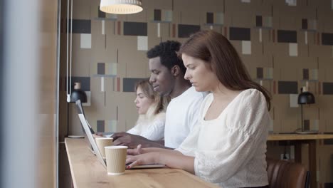 serious young professional sitting at counter with coffee